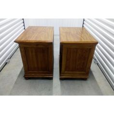 two wooden nightstands sitting next to each other