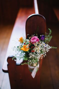 a bouquet of flowers sitting on top of a wooden bench