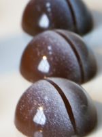 three chocolate candies are lined up on a table