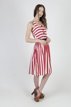 "Vintage 80s summer festival midi dress. Tailored tank bodice with button down front. Gathered elastic waist with sweeping skirt. Red and white striped cotton material. size estimate: M shoulders: - bust: 27\" - 36\" waist: 22\" - 34\" hips: - total length: 41\" * Visit the shop * https://www.etsy.com/shop/americanarchive Model is 5'9\" Belts and other accessories are not included." 80s Summer, Skirt Summer, Holiday Party Dresses, Holiday Party Outfit, White Striped Dress, Red And White Stripes, Summer Festival, Holiday Dresses, Full Skirt