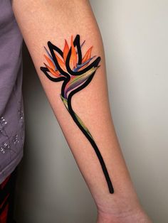 a colorful flower tattoo on the arm