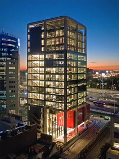 an office building lit up at night in the city