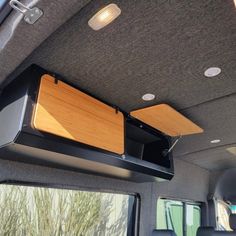 the inside of a vehicle with two speakers on it's ceiling and an overhead entertainment system