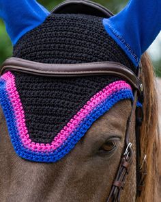 "Our handmade fly bonnets are the perfect choice for the adventurous equestrian looking for something beyond the ordinary. Each fly bonnet boasts intricate and skilled craftsmanship to ensure quality and durability. The stylish design and exquisite crochet work will make a statement, while breathable material and tailored design will keep your horse cool and comfortable.  Ships in 5-6 weeks. **DETAILS** * Soft cotton blend yarn and cotton jersey ears * Paracord throat tie for security * Machine wash, lay flat to dry **Size** Pony size measures 13\" across the browband and 13\" from poll to tip. Ears measure 6.5\" along the back of the ear. Cob size measures 14\" across the browband and 14\" from poll to tip. Ears measure 7\" along the back of the ear. Horse size measures 15\" across the br Custom Bonnets, Boot Tree, Saddle Pads English, Western Saddle Pads, Bisexual Flag, Saddle Cover, Lgbtq Flags, Crochet Work, Tailored Design