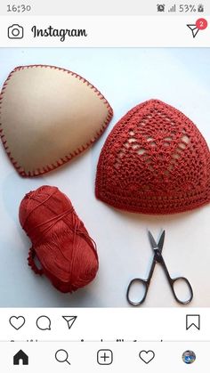 two crocheted hearts, a ball of yarn and a pair of scissors