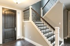 an empty entryway with stairs leading up to the second floor and another door on the other side