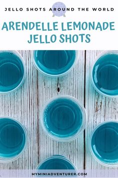 blue jello shots sitting on top of a wooden table with text overlay that reads,