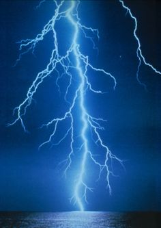 a lightning strike over the ocean at night