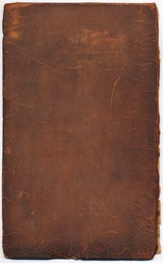 an old brown leather book with some writing on it