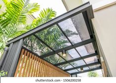 a house with wooden slats and green plants