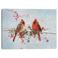 two red birds sitting on a branch with berries in the foreground and snow covered ground behind them