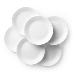 six white plates stacked on top of each other