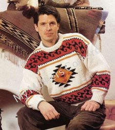 a man sitting on top of a chair wearing a sweater