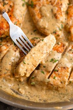 chicken with gravy in a skillet with a fork sticking out of it