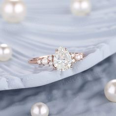 a close up of a ring with pearls around it