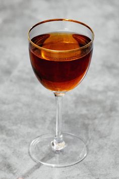 a glass filled with liquid sitting on top of a table