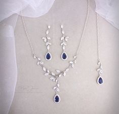 a necklace and earring set with blue stones