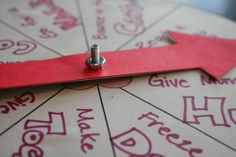 a close up of a piece of paper with words on it and a pin in the middle