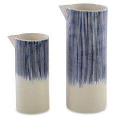 two blue and white vases sitting next to each other