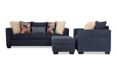 a blue couch and ottoman with pillows on it