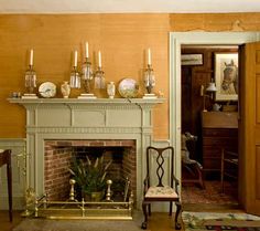 a living room filled with furniture and a fire place in front of a painting on the wall