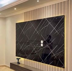 a large black and white marble wall mounted to the side of a wooden floored room