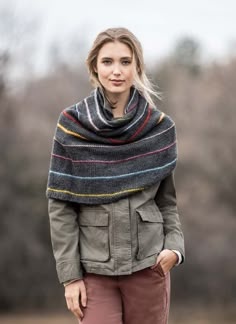 a woman wearing a gray jacket and striped shawl