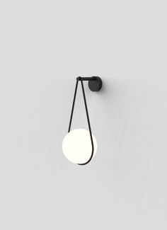 a wall light that is on the side of a wall with a black cord attached to it