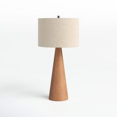 a wooden table lamp with a white shade on it