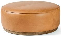 a tan leather ottoman sitting on top of a wooden base