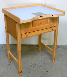 a wooden desk with two drawers on it