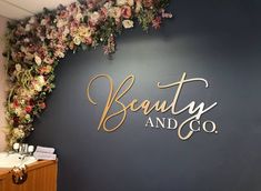 the beauty and co logo is painted on a wall