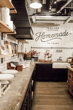 an industrial style kitchen with white brick walls and wood flooring that has the words homemade written on it