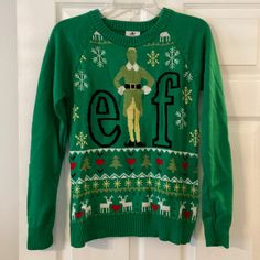 an elf sweater hanging on a door