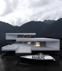 a boat floating on top of a body of water next to a white house in the middle of mountains