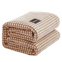 three blankets stacked on top of each other in beige and white checkerboard pattern