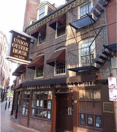 an old brick building with stairs leading up to the upper floor and second story windows