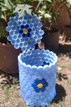 two vases made out of plastic cups