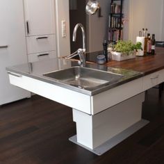 a kitchen with a sink and wooden counter tops