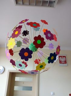 a paper flower umbrella hanging from the ceiling