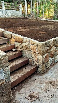 a stone wall with steps leading up to it