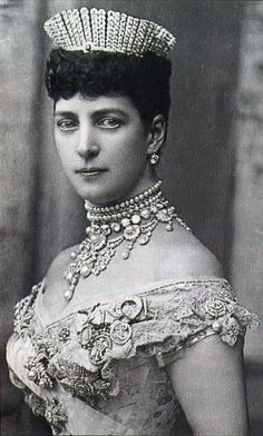 an old black and white photo of a woman wearing a tiara