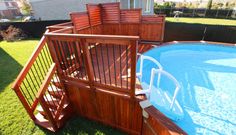 an above ground pool surrounded by wooden decks