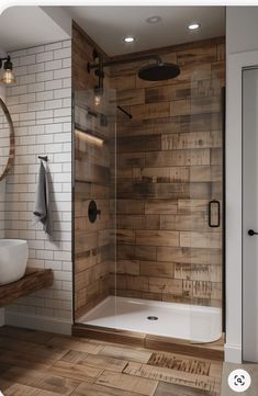 a bathroom with wood flooring and white tile on the walls, along with a walk in shower