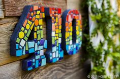 the word art is made out of stained glass and wooden planks with colorful tiles on it