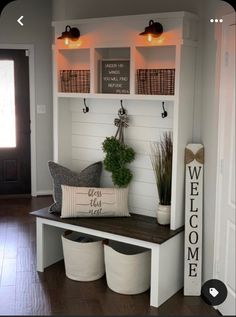 a white bench with some plants on top of it and two baskets below the bench