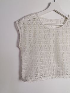 Beautiful off-white sheer crochet knit crop top, fringed hem/ Excellent vintage condition. Would fit size XS. Model wears size 8-10 UK, S-M US, is 160 cm tall and weighs 54 kg. All of our items are freshly laundered with quality detergents and fabric softeners, absolutely ready to wear the moment you receive them! Keep in mind, this item is vintage and subtle signs of passing time may be present, adding to its character and making it even more worthy of your love. For more info, additional photo Crew Neck White Crochet Top With Knit Fabrication, White Crew Neck Crochet Top With Knit Fabrication, White Crochet Crew Neck Top With Knit Fabrication, White Crochet Crew Neck Top, White Open Knit Lace Top, White Bohemian Knit Top With Crochet Lace, White Lace Top With Open Knit Detail, Bohemian Cropped Open Knit Tops, White Cropped Crochet Top With Lace Trim