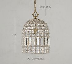 a chandelier hanging from a chain with measurements for the size and width in front of it