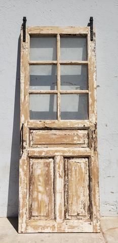 an old wooden window sitting on the side of a building