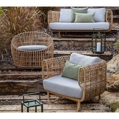 three wicker chairs sitting on top of steps next to each other with green pillows